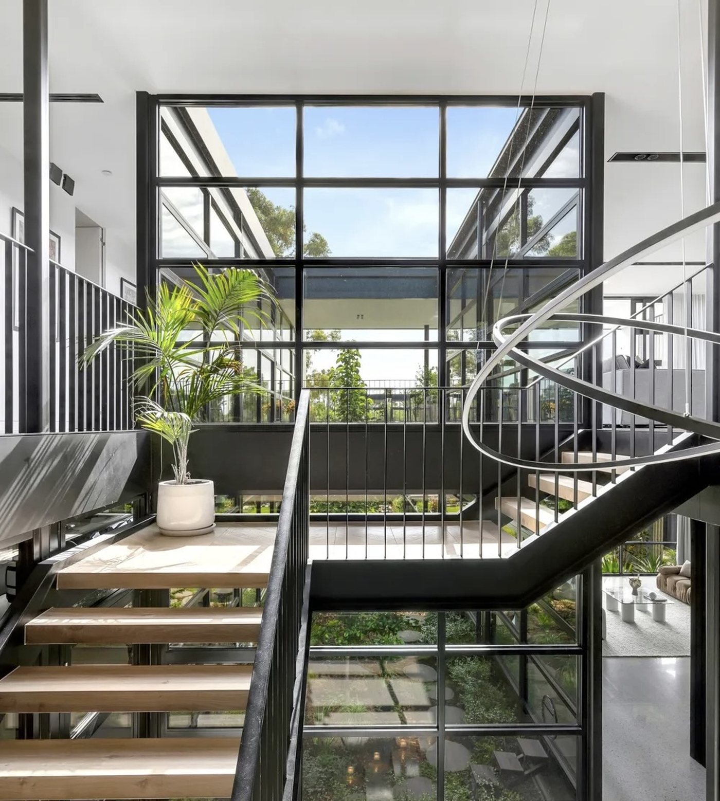 Double-height atrium and staircase with black-framed glazing after a Pristine interior window clean