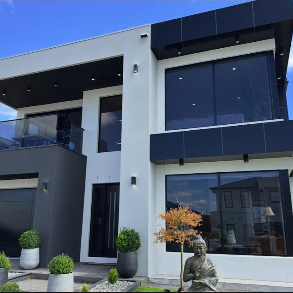 Modern two-storey home exterior with freshly cleaned floor-to-ceiling windows