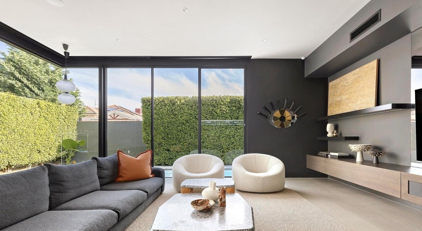 Living room with full-height sliding glass doors opening to the pool, Melbourne