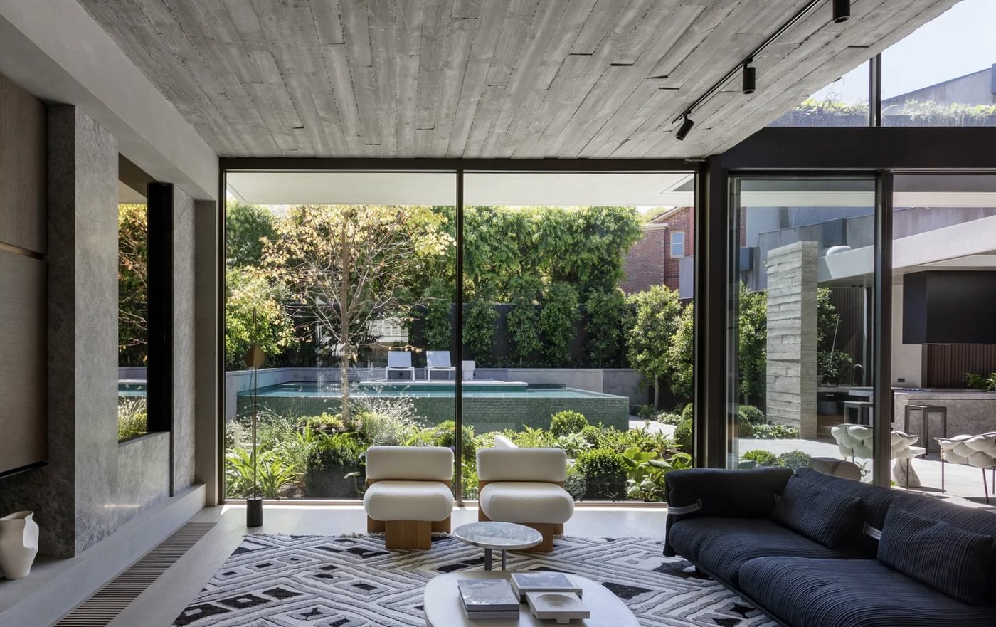 Living room with full-height glazing overlooking the pool after a Pristine clean, Melbourne