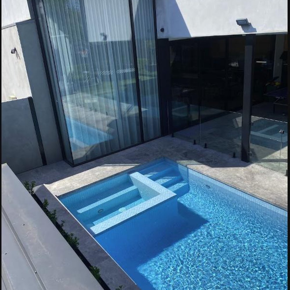Streak-free glass balustrade and doors beside a plunge pool